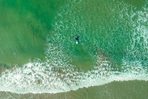 surf instructor and woman learning extreme water sport in Goa.