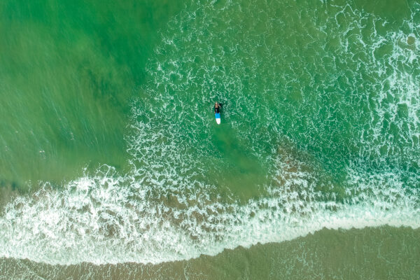 surf instructor and woman learning extreme water sport in Goa.