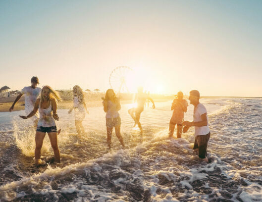 happy-friends-having-fun-on-the-beach-at-sunset-in-formentera