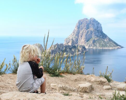 Boy is looking at the sea in es vedra in ibiza